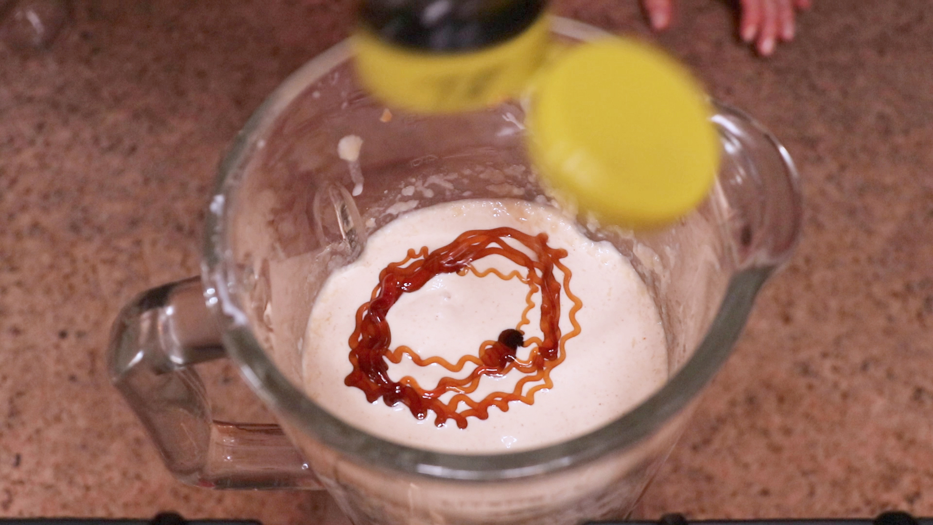 Honey being poured into a blender