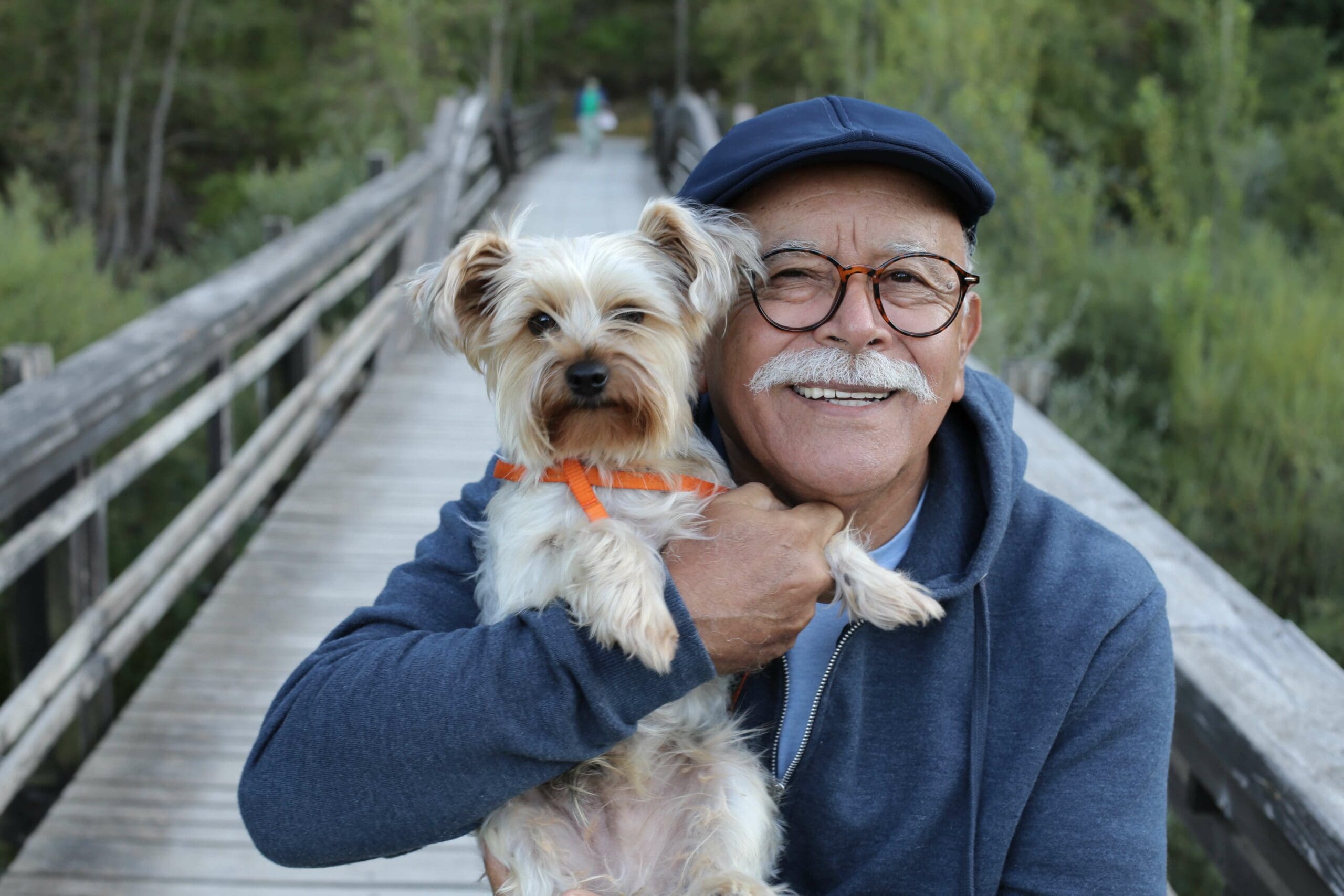 Smiling man hold his dog.