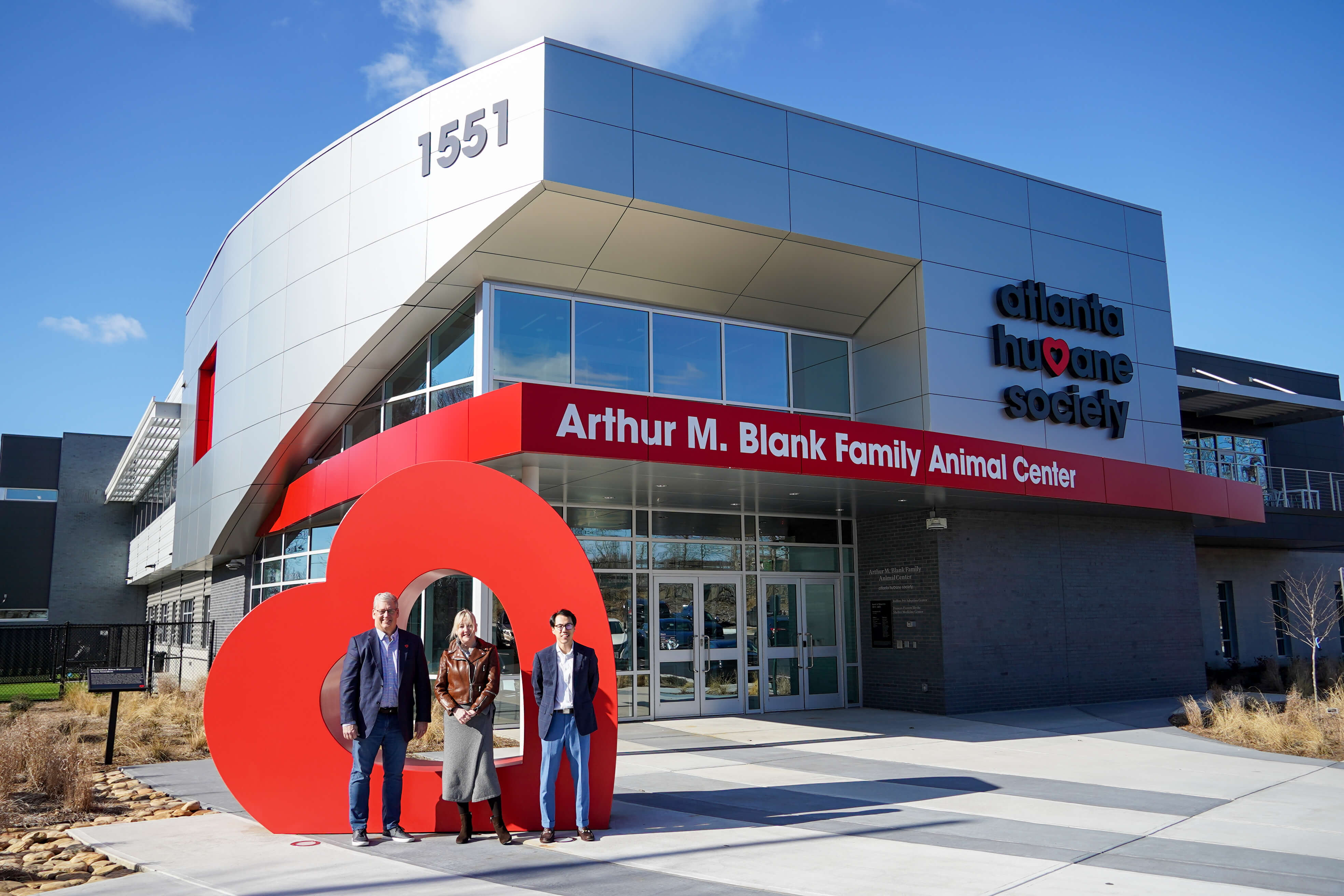 New Board Members stand in front of a heart shaped sculpture at the Atlanta Humane Society